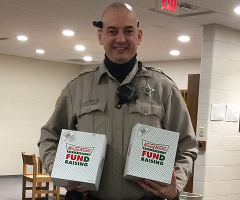 SRO Pederson helping out a senior trip fundraiser by buying two boxes of Donuts